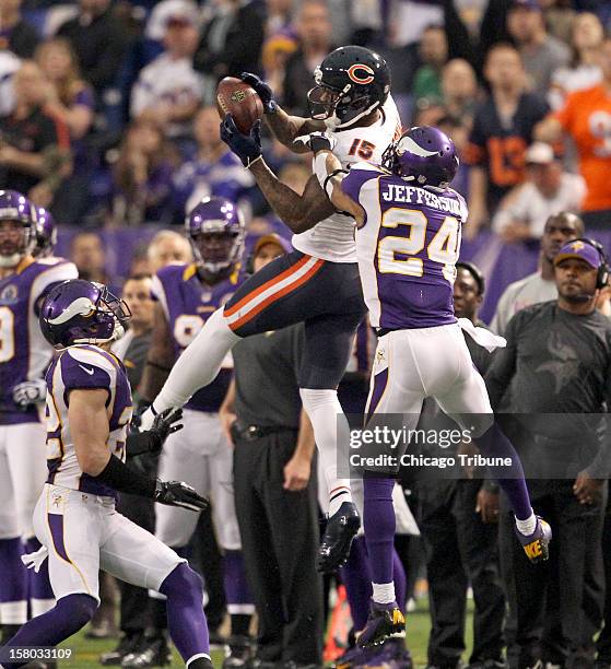 Chicago Bears wide receiver Brandon Marshall hauls in a long pass while being guarded by Minnesota Vikings free safety Harrison Smith and Minnesota...