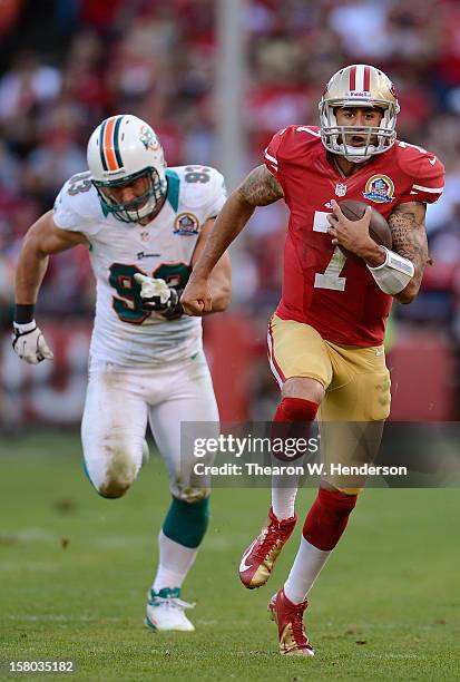 Colin Kaepernick of the San Francisco 49ers runs fifty yards for a touchdown against the Miami Dolphins in the fourth quarter at Candlestick Park on...