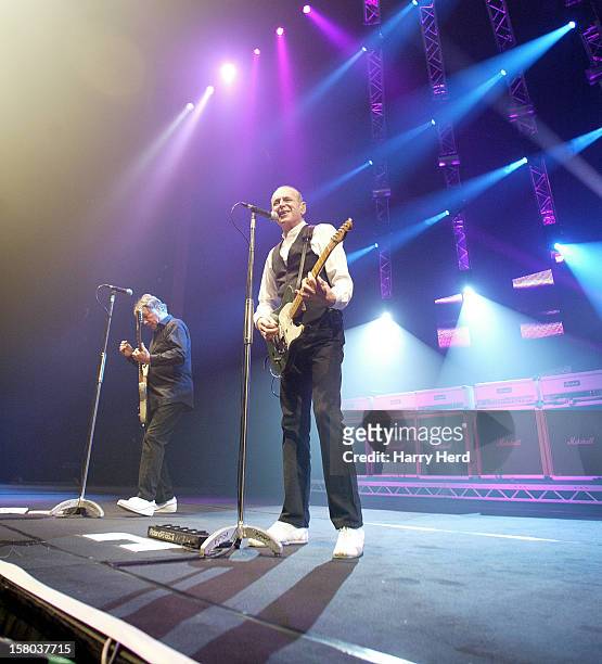 Rick Parfitt and Francis Rossi of Status Quo perform at Quofestive at the BIC on December 9, 2012 in Bournemouth, England.