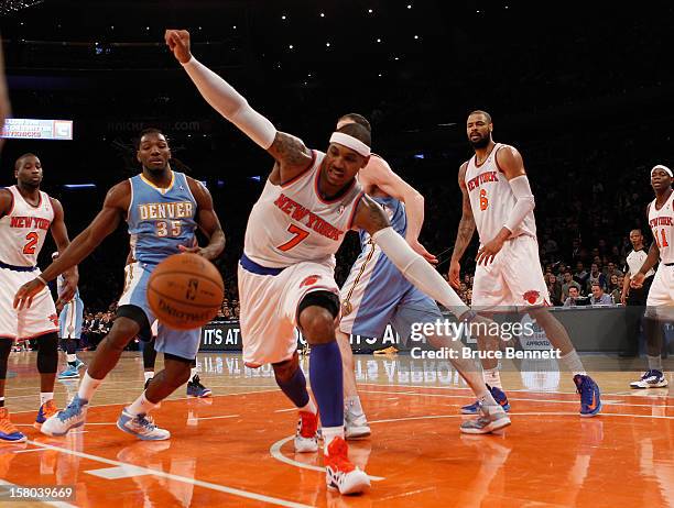 Carmelo Anthony of the New York Knicks pursues a ball as it goes out of bounds in the game against the Denver Nuggets at Madison Square Garden on...