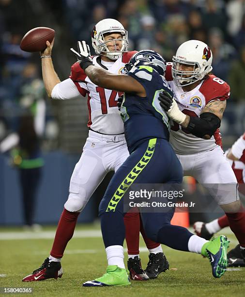 Quarterback Ryan Lindley of the Arizona Cardinals passes under pressure from defensive end Greg Scruggs of the Seattle Seahawks at CenturyLink Field...