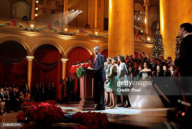 President Barack Obama speaks during the "Christmas in Washington" concert with first lady Michelle Obama and daughters Malia and Sasha Obama at the...