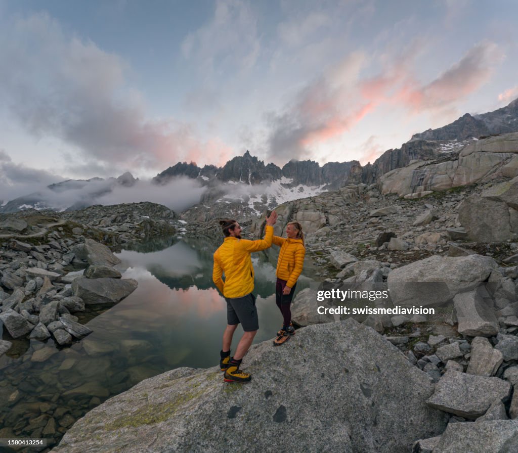 Hiker at sunrise high five