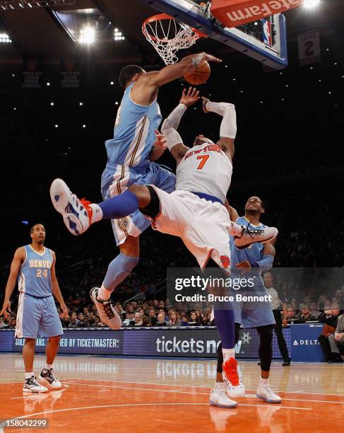 Carmelo Anthony of the New York Knicks is blocked in his game against the Denver Nuggets at Madison Square Garden on December 9, 2012 in New York...