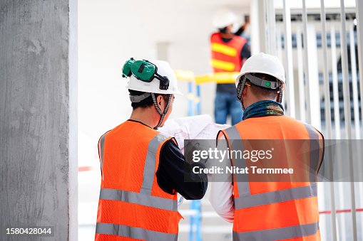 Problem-Solving and Decision-Making is a Key in Construction Operations. Team construction engineers discuss a blueprint or project task details at a construction site. Problem-Solving and Decision-Making is a Key in Construction Operations. Team construction engineers discuss a blueprint or project task details at a construction site.