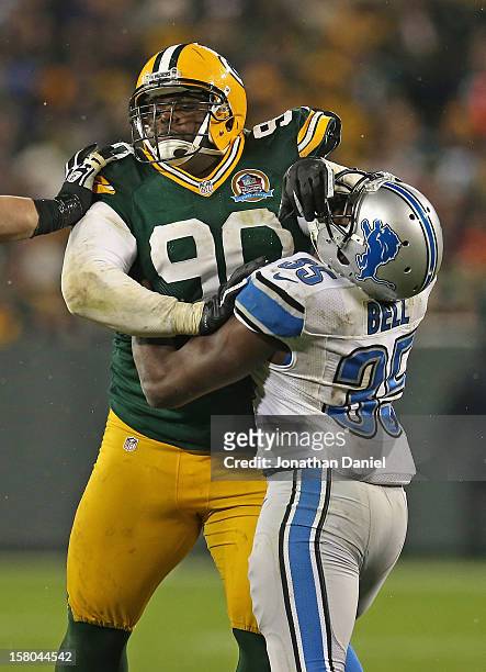 Raji of the Green Bay Packers rushes against Joique Bell of the Detroit Lions at Lambeau Field on December 9, 2012 in Green Bay, Wisconsin. The...