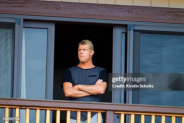 Mick Fanning of Australia watches the conditions from his house during the Billabong Pipe Masters on December 9, 2012 in North Shore, Hawaii.