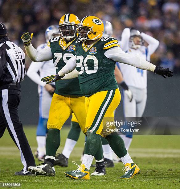 Raji and Ryan Pickett of the Green Bay Packers signal no good as Jason Hanson of the Detroit Lions reacts to his missed field goal at Lambeau Field...