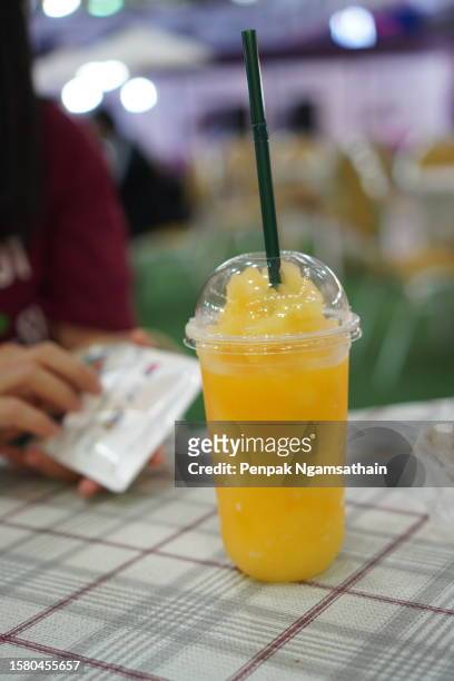 orange juice in plastic cup - snösörja bildbanksfoton och bilder