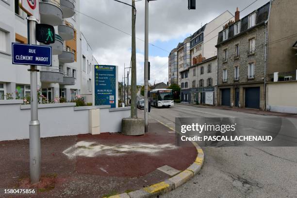 This photograph taken on August 6 shows white traces and traces of oil on the ground indicating the location where the scooter stopped, after two men...