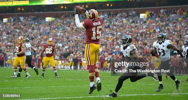 Washington's wide receiver Josh Morgan catches a touchdown pass early in the first quarter to make the score 7-0 Washington as the Washington...