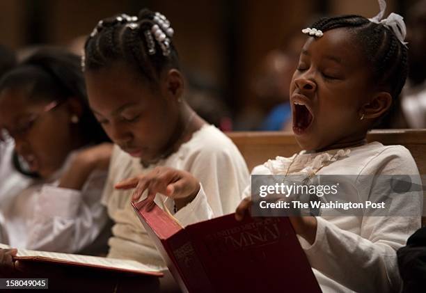 Faith Thomas and Alyssa Bruce , members of the Rhythm Starters, study Hymnal books prior to performing at First United Methodist Church of...