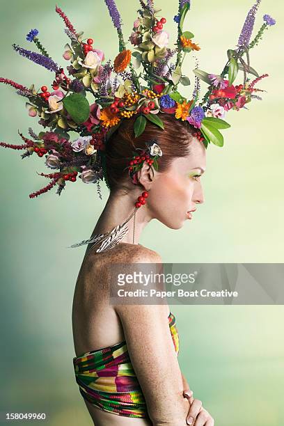 woman wearing a colorful floral mohawk - hairstyle stock-fotos und bilder