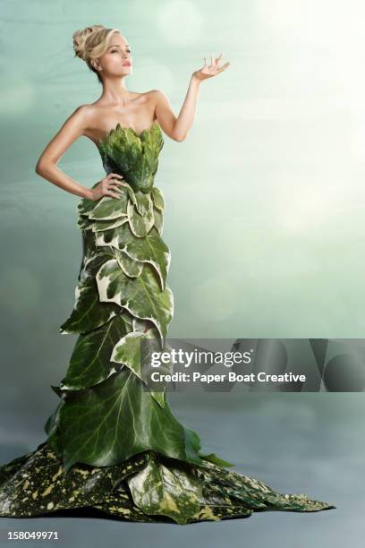 woman wearing a long gown made of leaves - long green dress stock pictures, royalty-free photos & images