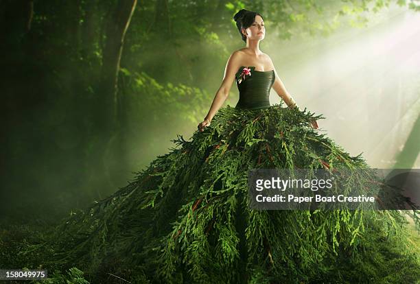woman wearing a large green gown in the forest - green dress fotografías e imágenes de stock