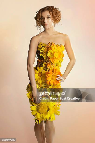 young lady wearing a dress made of yellow flowers - paper gown stock pictures, royalty-free photos & images