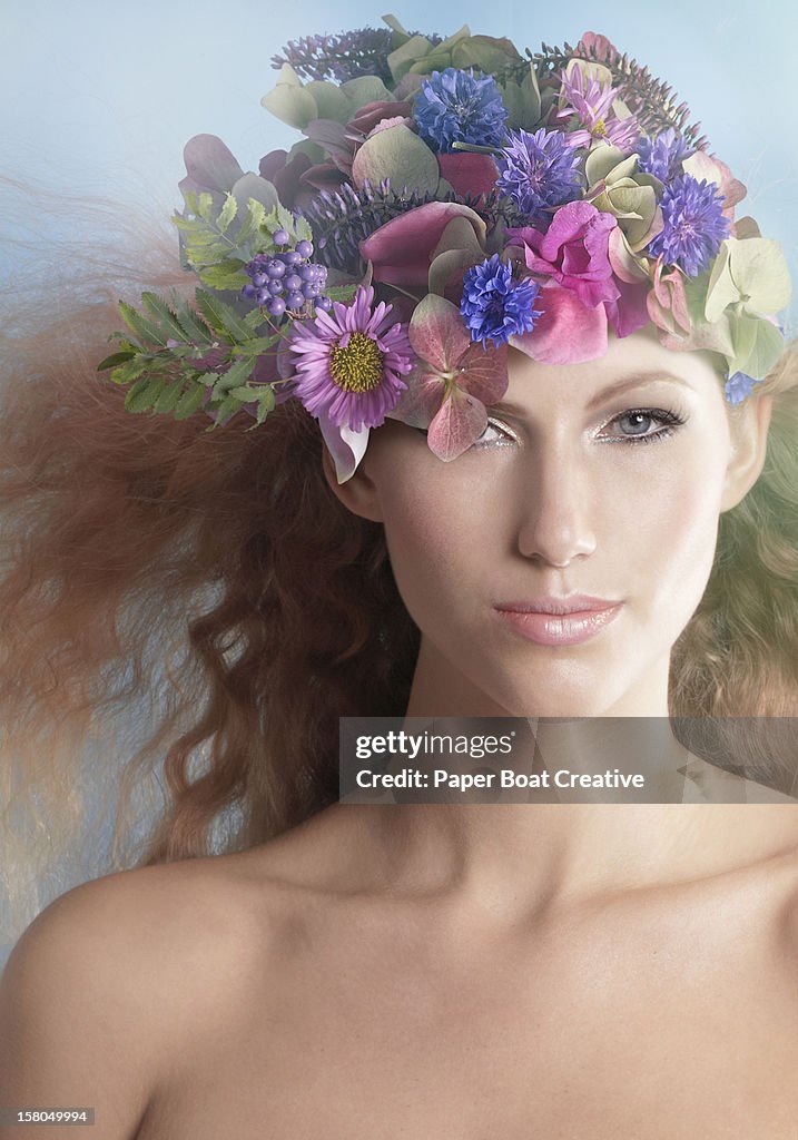 Lady wearing a hat made of flower and leaves