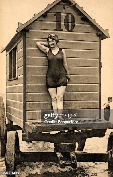 Bathing beauty in front of a portable bathing hut in Ostend, Belgium, circa 1920.