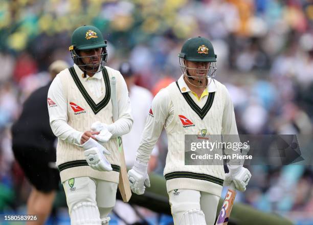 Usman Khawaja and David Warner of Australia walk off the field for lunch after the first session during Day Four of the LV= Insurance Ashes 5th Test...