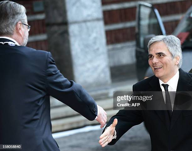 Austrian prime minister Werner Faymann is greeted by Oslo mayor Fabian Stang outside the City Hall prior to the Nobel Peace Prize ceremony in Oslo,...