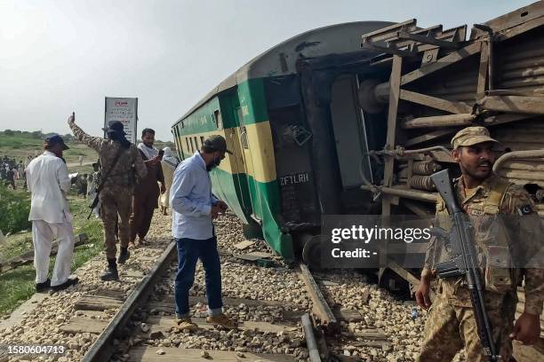 Paramilitary Rangers inspect the carriages following the derailment of a passenger train in Nawabshah, in the Pakistan's southern Sindh province on...