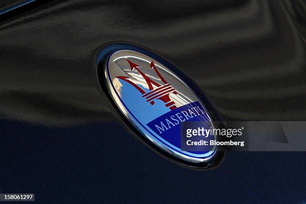 Logo sits on the hood of a new Quattroporte V8 automobile, produced by Maserati, the luxury-auto maker owned by Fiat SpA, during its debut in Nice,...