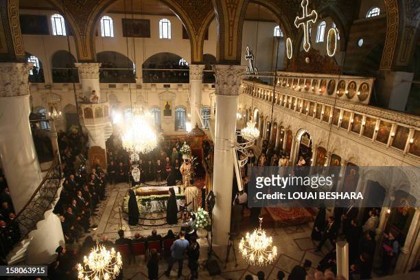 Syrian mourners attend the funeral of Greek Orthodox patriarch of Syria, Ignatius IV Hazim, at the Meriamiah Church in the Syrian capital Damascus on...