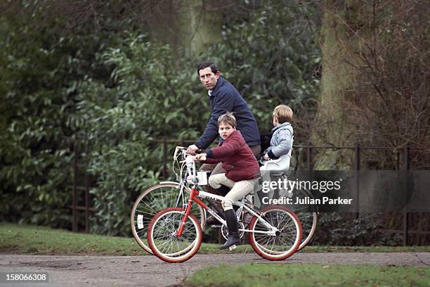 Prince Charles, Prince William And Prince Harry On Bikes Returning From The Stables, At Sandringham Estate, In Norfolk.