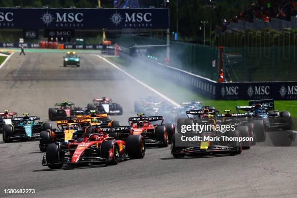 Charles Leclerc of Monaco driving the Ferrari SF-23 leads Sergio Perez of Mexico driving the Oracle Red Bull Racing RB19 and the rest of the field...