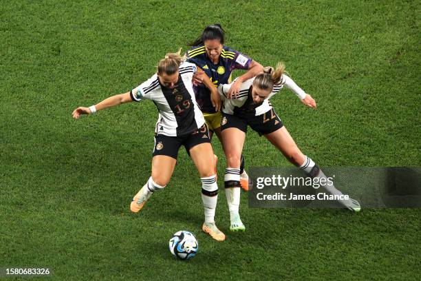 Lady Andrade of Colombia battles for the ball with Klara Buehl and Jule Brand of Germany during the FIFA Women's World Cup Australia & New Zealand...