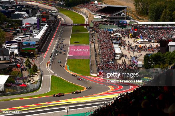 Charles Leclerc of Monaco driving the Ferrari SF-23 leads Sergio Perez of Mexico driving the Oracle Red Bull Racing RB19 and the rest of the field at...