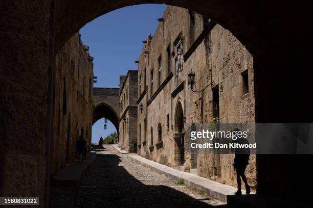 Quiet street at lunch time in the old town on July 30, 2023 in Rhodes, Greece. While Rhodes town itself wasn't directly affected by fire damage or...