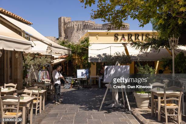 An empty restaurant at lunch time in the old town on July 30, 2023 in Rhodes, Greece. While Rhodes town itself wasn't directly affected by fire...