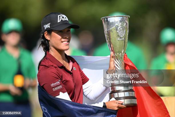 Celine Boutier of France celebrates with the Amundi Evian Championship trophy following victory in the Amundi Evian Championship at Evian Resort Golf...