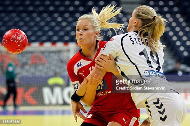 Lotte Grigel of Denmark is challenged by Helena Sterbova of Czech Republic during the Women's European Handball Championship 2012 Group I main round...