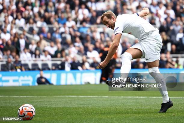 Tottenham Hotspur's English striker Harry Kane shoots to score his third goal during the pre-season friendly football match between Tottenham Hotspur...