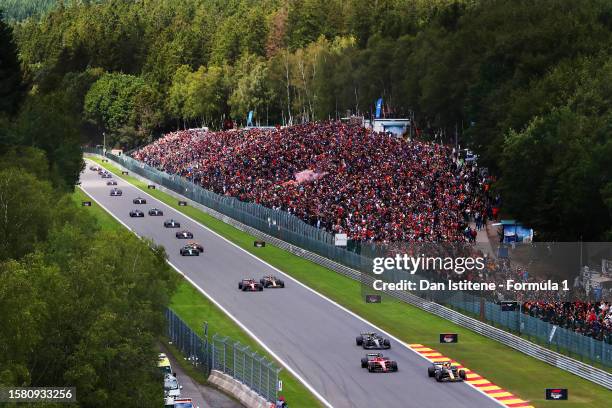 Sergio Perez of Mexico driving the Oracle Red Bull Racing RB19 leads Charles Leclerc of Monaco driving the Ferrari SF-23 and rest of the field at the...