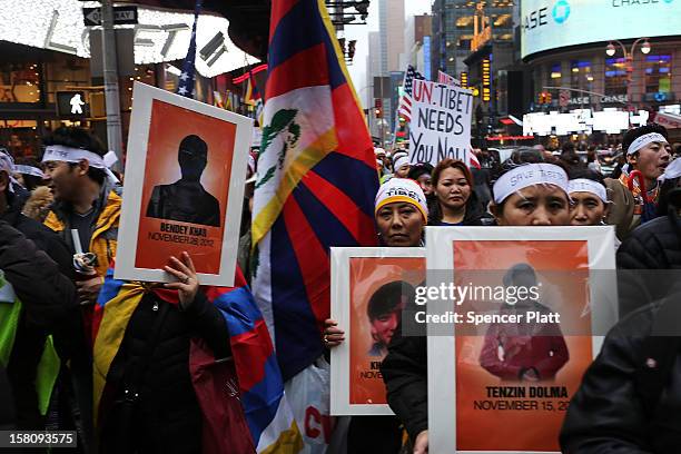 Carrying posters of people who have self-immolated themselves, protestors march down 42nd street to the United Nations General Assembly Building in...
