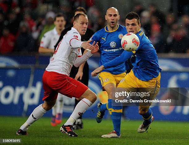 Kevin McKenna of Cologne chases Orhan Ademi of Braunschweig during the Bundesliga match between 1. FC Koeln and Eintracht Braunschweig at...