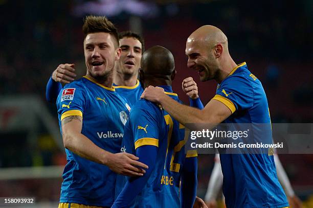 Dominik Kumbela of Braunschweig celebrates with teammates after scoring his team's first goal during the Bundesliga match between 1. FC Koeln and...