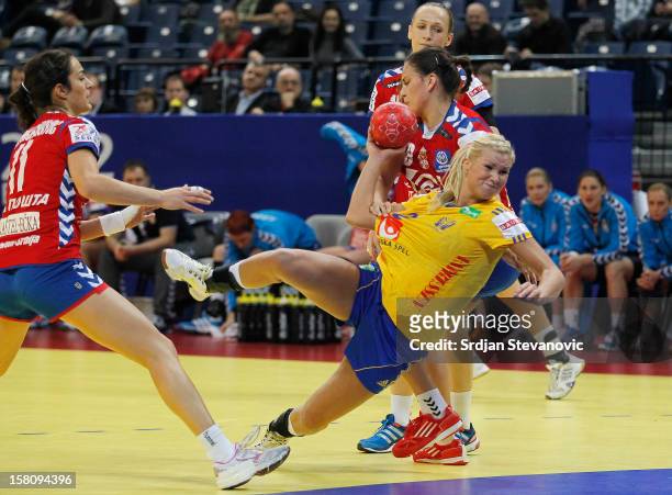 Ulrika Agren of Sweden is challenged by Sladjana Pop-Lazic of Serbia during the Women's European Handball Championship 2012 Group I main round match...