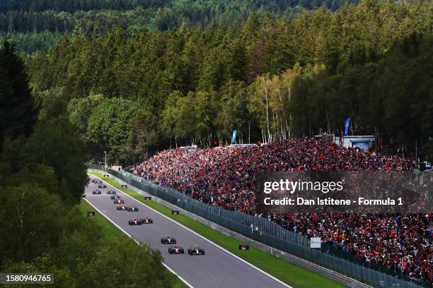 Sergio Perez of Mexico driving the Oracle Red Bull Racing RB19 leads Charles Leclerc of Monaco driving the Ferrari SF-23 and rest of the field at the...
