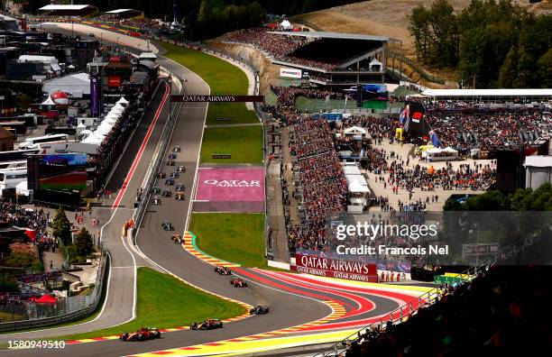 Charles Leclerc of Monaco driving the Ferrari SF-23 leads Sergio Perez of Mexico driving the Oracle Red Bull Racing RB19 and the rest of the field at...