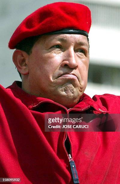 President of Venezuela Hugo Chávez watches supporters during the 'march for peace and democracy' in Caracas 13 October 2002. Tens of thousands of...