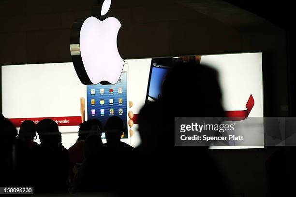 People walk through the Apple retail store in Grand Central Terminal on December 10, 2012 in New York City. Apple Inc. Stock was down $4.56 per...