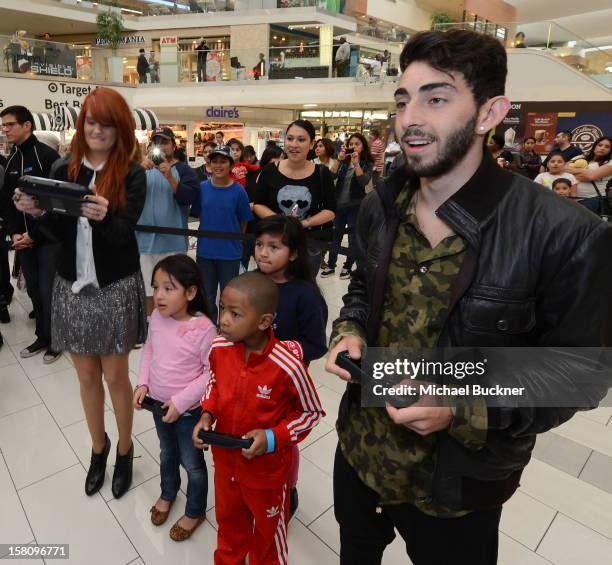 Debby Ryan and Mateo Arias stars of Disney XD’s hit series "Kickin’ It" gets ready to battle in the Wii U Showdown at Westfield Century City Mall in...