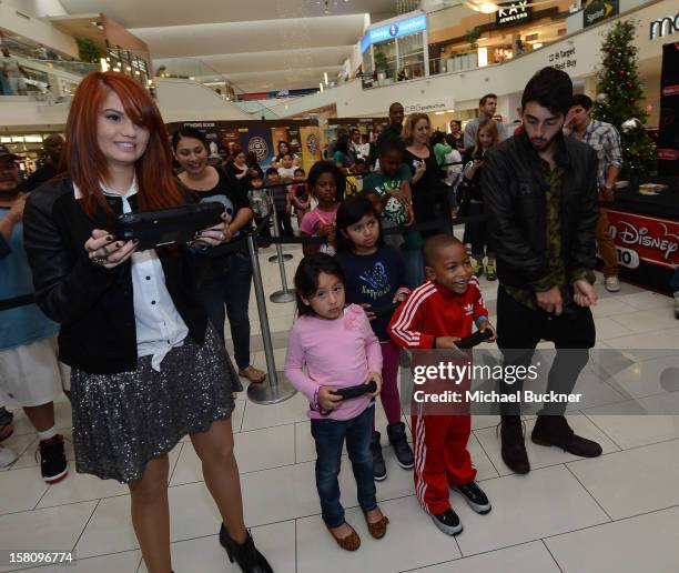 Debby Ryan and Mateo Arias stars of Disney XD’s hit series "Kickin’ It" gets ready to battle in the Wii U Showdown at Westfield Century City Mall in...