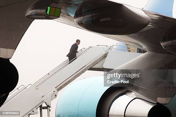 President Barack Obama boards Air Force One Decmber 10, 2012 at Joint Base Andrews, Maryland. Obama was traveling to the Daimler Detroit Diesel...