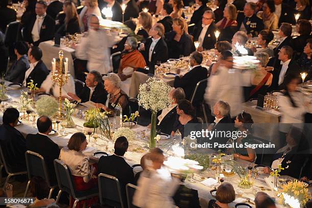 Staff serve guests at the main table during the Nobel Banquet after the 2012 Nobel Prize Ceremony at Town Hall on December 10, 2012 in Stockholm,...