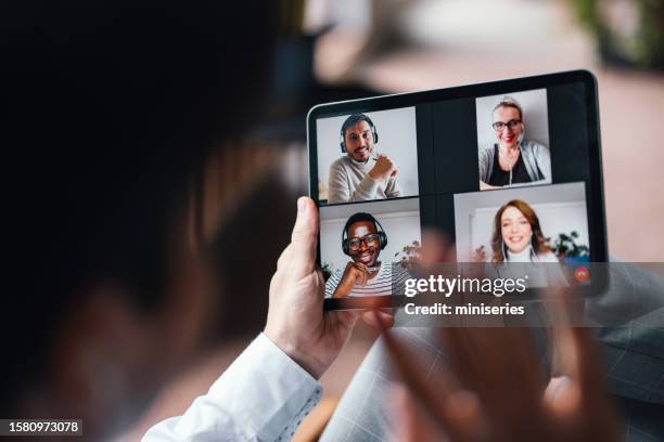 anonymous man holding a digital tablet and using it for a group video call (copy space) - dress code stock pictures, royalty-free photos & images